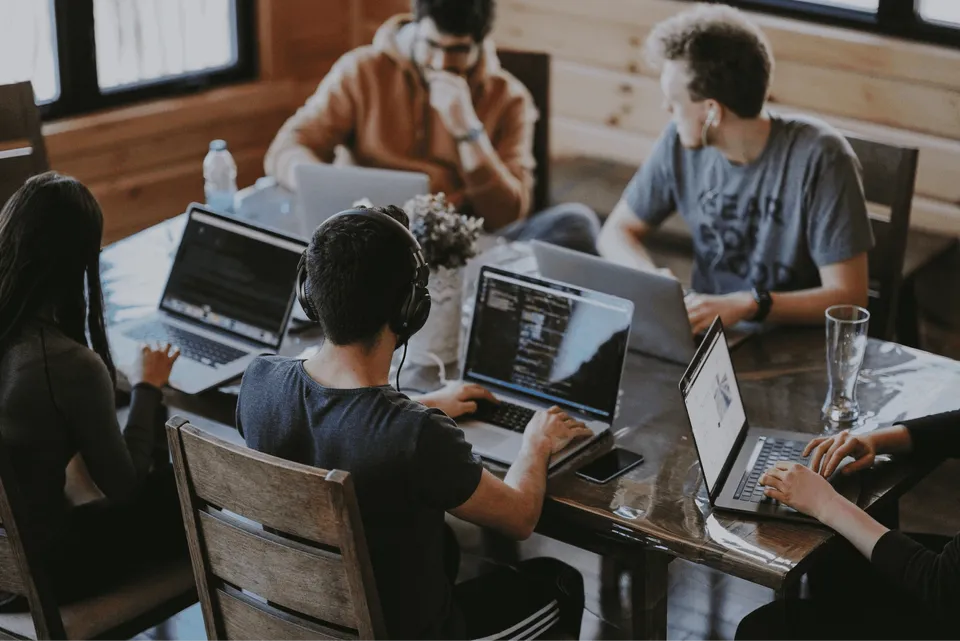Engineers collaborating around a laptop